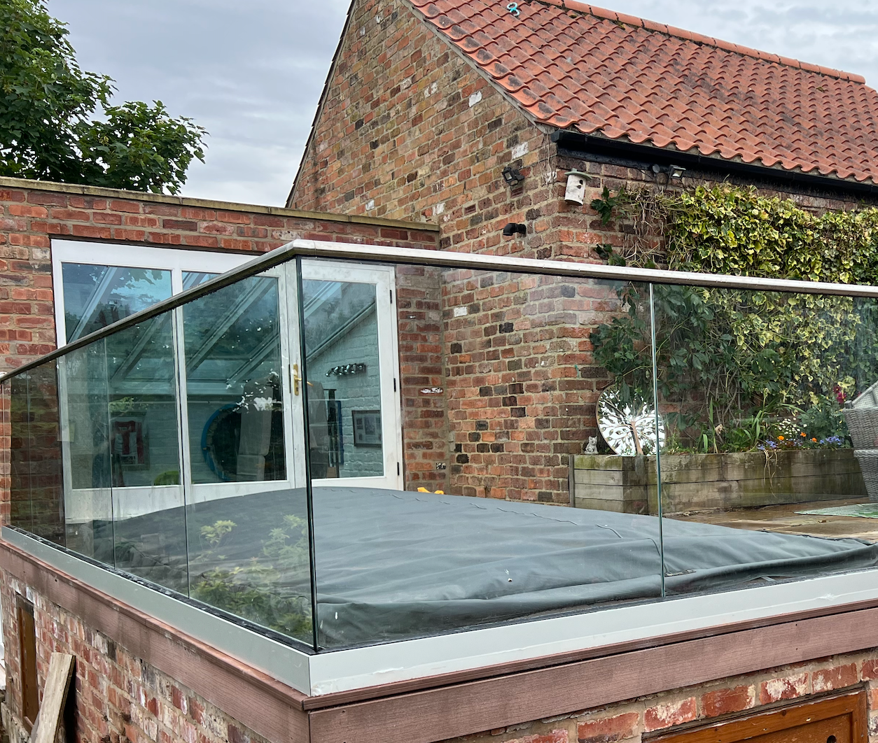 Glass balustrade handrail system installed on a modern balcony