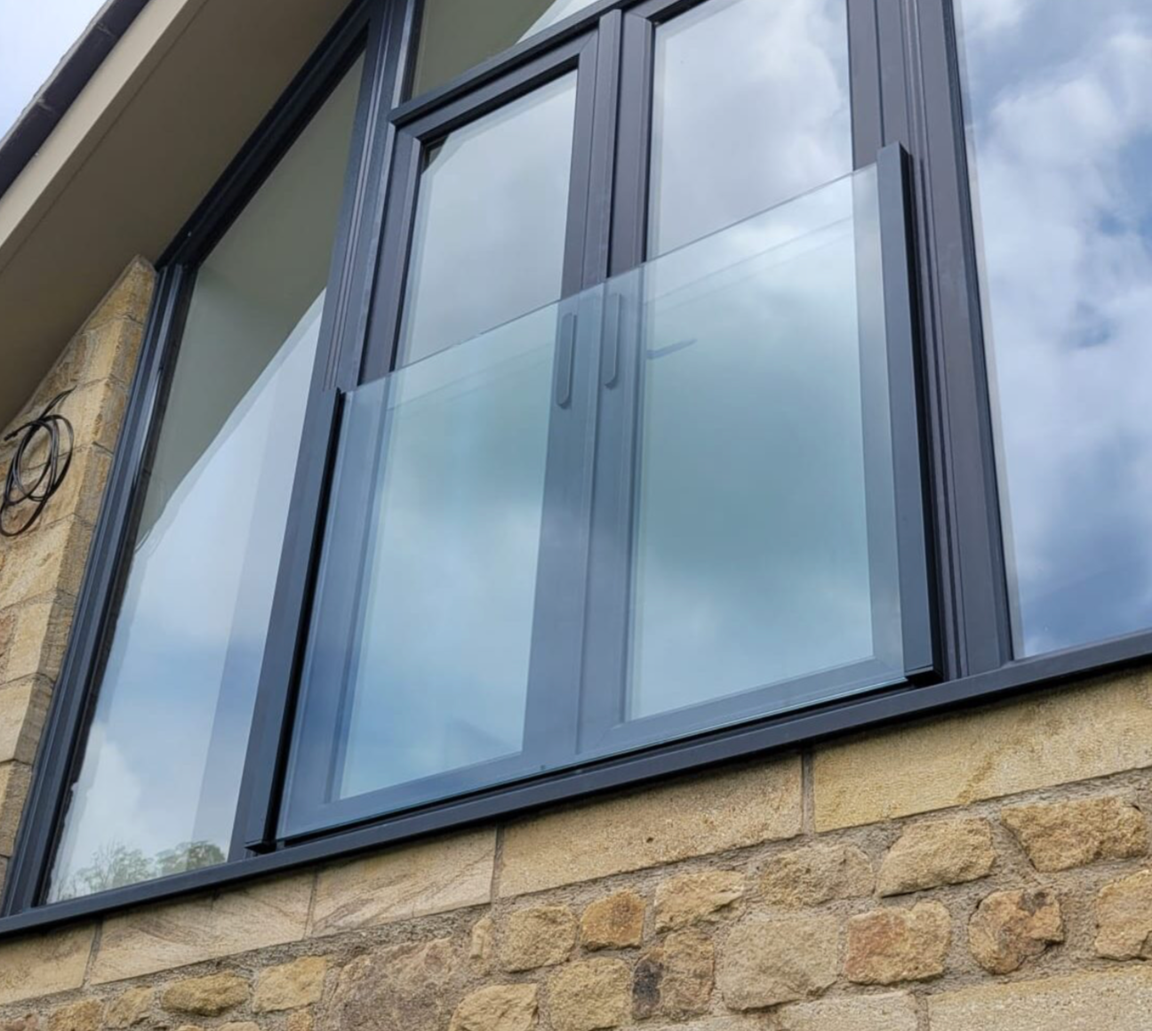 Installing the glass panel into the ONLEVEL SKYFORCE Juliet balcony system